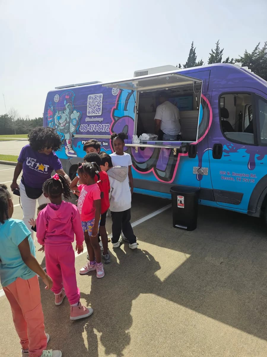 Children being served from the Iced Out truck at a Cedar Hill Action Team event