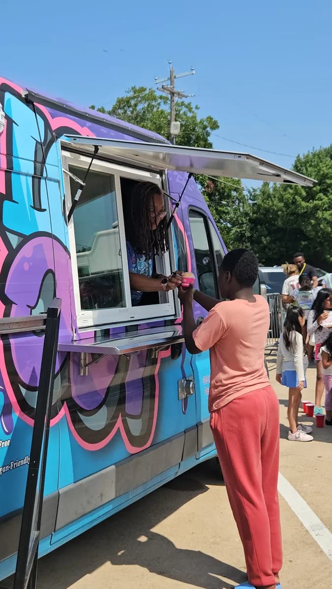 Iced Out serving a guest from the truck at a Dream Center Dallas back-to-school event