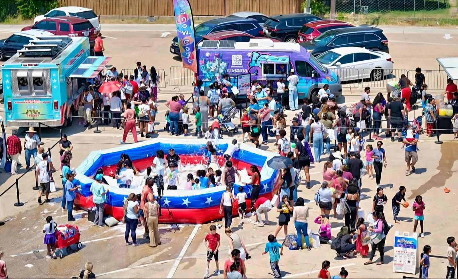 Crowd gathered around activities and the Iced Out truck at Dream Center Dallas