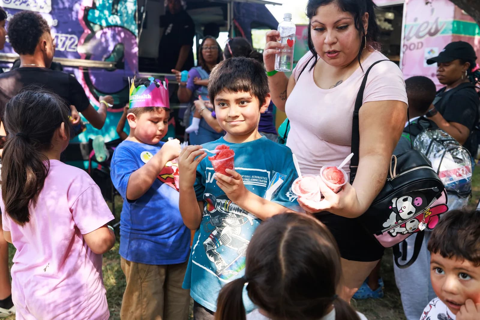 Children enjoying Iced Out cups at a For Oak Cliff community event