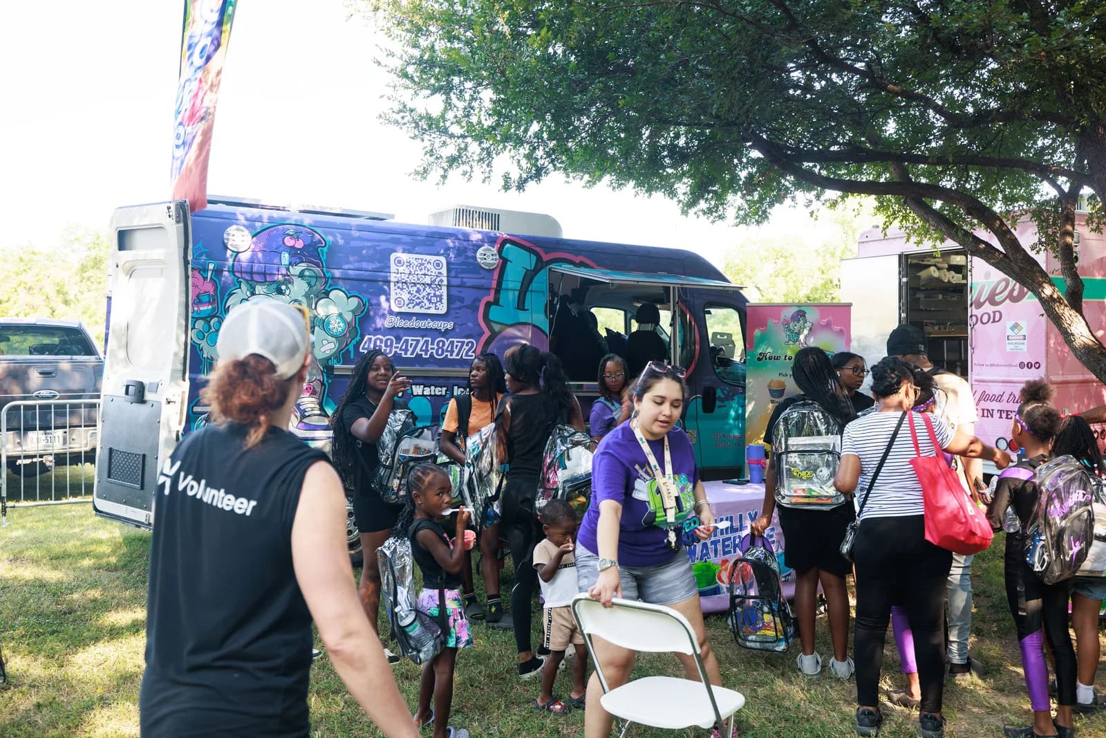 Community members gathered around the Iced Out truck at a For Oak Cliff event