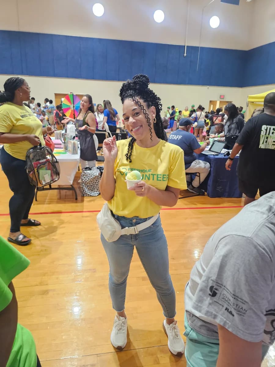 A FreshQue volunteer holding an Iced Out cup at a Mercy Street Dallas resource event