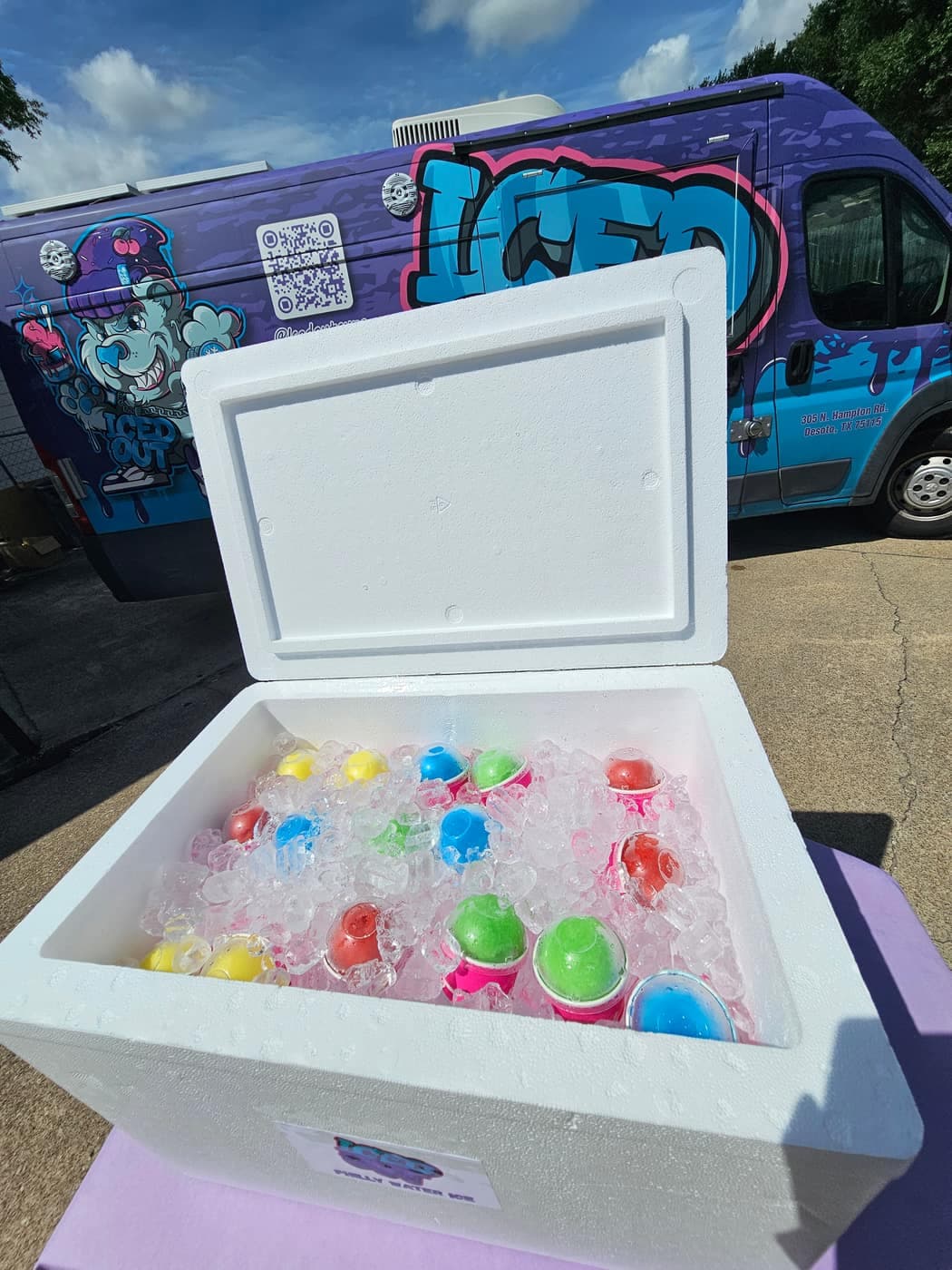 Open cooler full of colorful pre-scooped Iced Out water ice cups